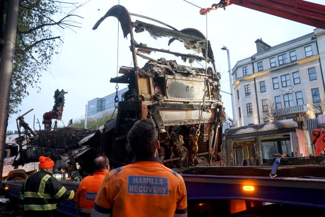 A burned out bus is removed from O'Connell Street in Dublin