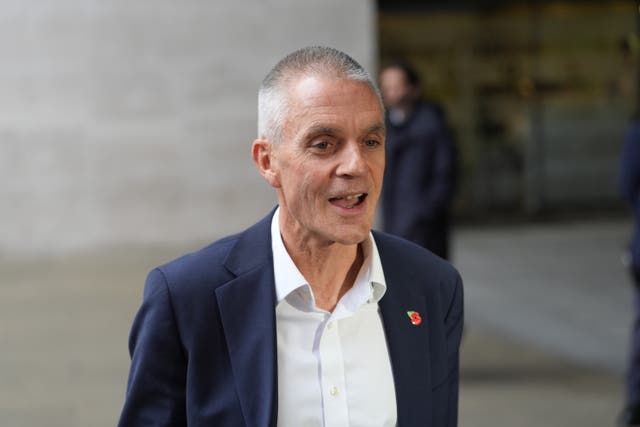 Tim Davie speaking while standing outside a building