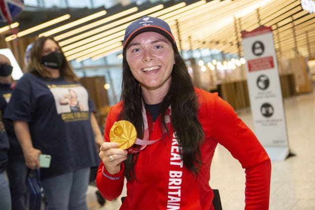 Lauren Rowles arrives back at Heathrow Airport with her gold medal from Tokyo