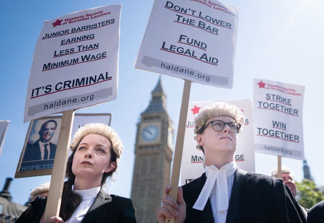 Criminal defence barristers outside the Houses of Parliament in London