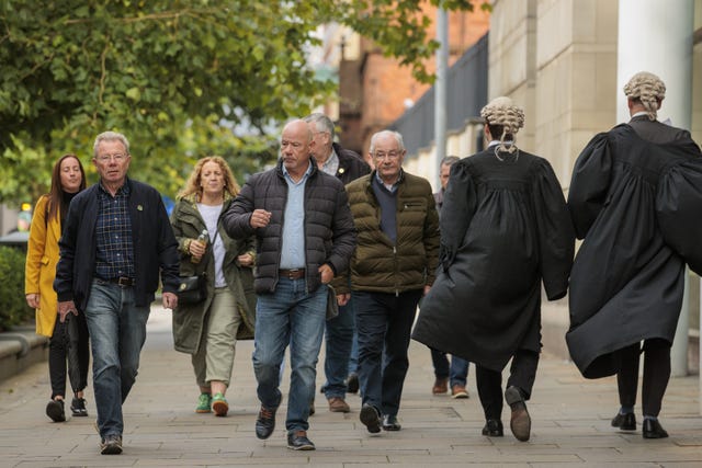 Joe McKinney (second left), John McKinney (centre left), and Mickey McKinney (centre right), the brothers of William McKinney, one of the men killed on Bloody Sunday in Londonderry in 1972, arrive at Belfast Crown Court