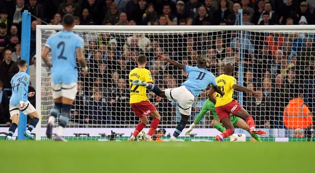 Jeremy Doku, centre right, scores Manchester City's first goal against Watford