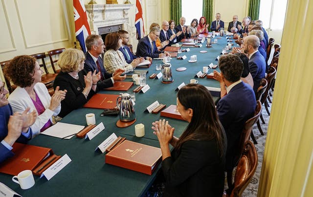 Cabinet ministers applaud during the first meeting of Sir Keir Starmer's cabinet after the election