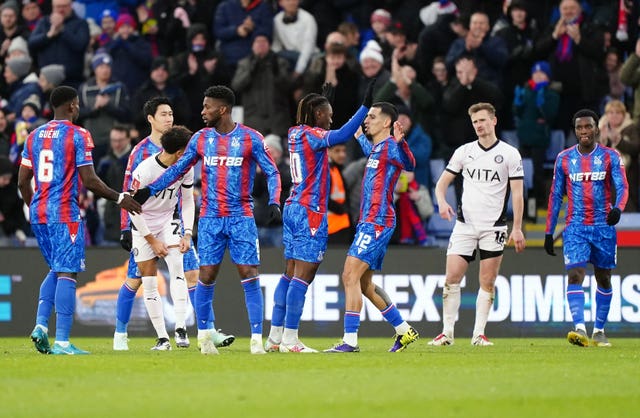 Crystal Palace’s Eberechi Eze (centre) celebrates scoring their side’s first goal of the game with team-mate Daniel Munoz during the Emirates FA Cup third round match at Selhurst Park, London.