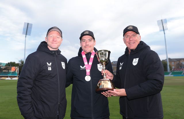 Gareth Batty, Rory Burns and Alec Stewart pose with the County Championship trophy