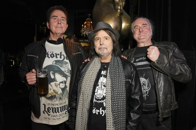 (left to right) Robert Kiewik, Phil Campbell and Mick Stevenson posing at Stringfellows nightclub in London, where the urn containing part of the ashes of Lemmy from Motorhead is placed behind the bar to honour the wishes in his will that part of his ashes be kept in an urn behind the bar of his favourite establishment