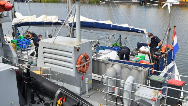 Drugs are unloaded from a boat by officers at Newlyn harbour 