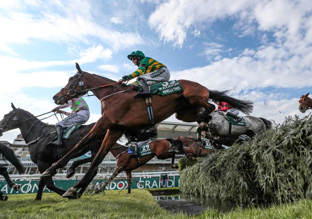 Minella Times ridden by Rachael Blackmore clears the water on the way to victory in the Grand National at Aintree. Blackmore became the first female jockey to win the famous race, which was held behind closed doors for the first time in its history