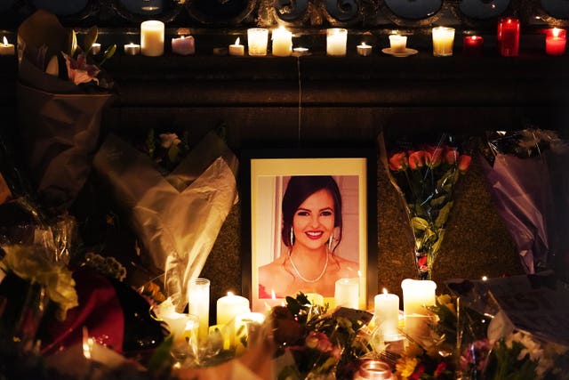 A photograph of Ashling Murphy among flowers and candles