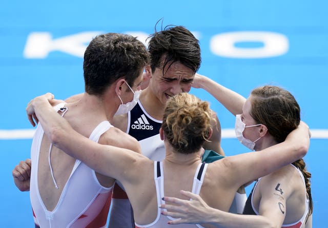 Alex Yee, second left, is congratulated by his relay team-mates, including Jonny Brownlee, left, after winning gold in Tokyo