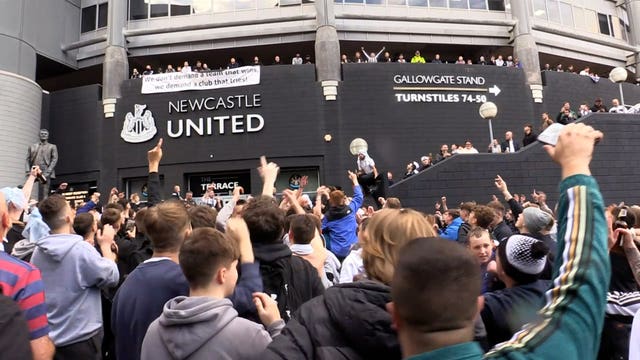 Newcastle fans celebrate confirmation of the Saudi-led takeover of the club in October 2021 