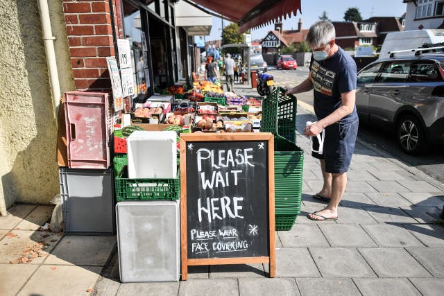 Signage outside a greengrocers advising shoppers to wear face coverings, on the High Street in Henleaze, Bristol, some six months on from the evening of March 23 when Prime Minister Boris Johnson announced nationwide restrictions 