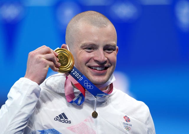 Adam Peaty shows off his gold medal