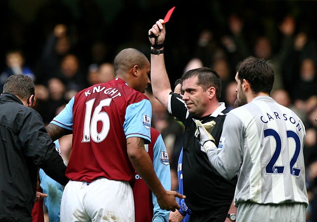 Referee Phil Dowd shows Aston Villa’s Zat Knight the red card