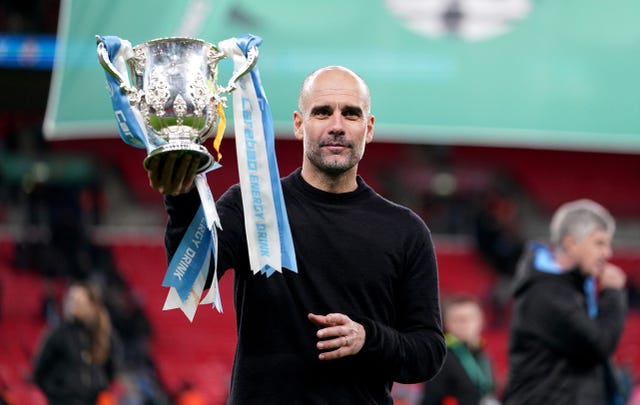 Pep Guardiola lifts the Carabao Cup trophy