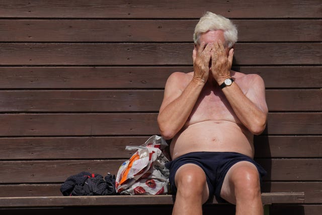 Pelham Wilson, 71, applies sun cream at Jesus Green Lido in Cambridge