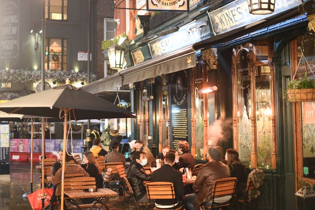 People sat outside a pub in the West End of London after the announcement that the capital and parts of Essex and Hertfordshire will face Tier 3 restrictions from Wednesday