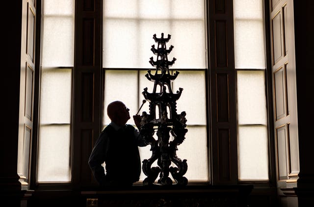 Castle Howard employee Dr Chris Ridgway cleans an ornate 17th-century Delft tulip vase (Danny Lawson/PA)