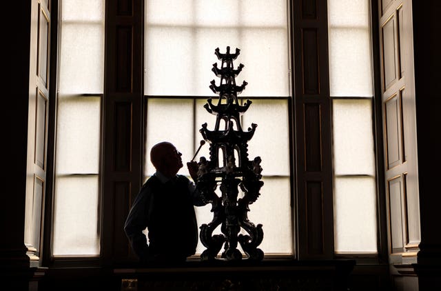 Castle Howard employee Dr Chris Ridgway cleans an ornate 17th-century Delft tulip vase (Danny Lawson/PA)