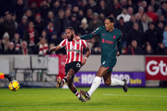 Van Dijk (right) in action in Liverpool's loss to Brentford before being substituted at half-time (John Walton/PA).