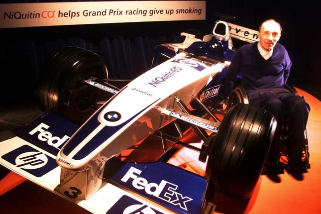 Formula One racing boss Frank Williams poses with the Williams F1 racing car in London