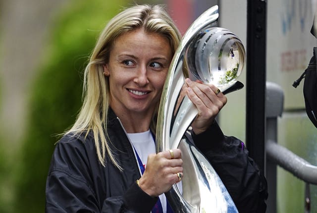 Leah Williamson pictured with the Euro trophy as she leaves the team hotel in Switzerland