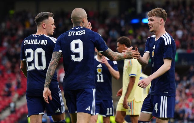Tyler Fletcher celebrates with Lyndon Dykes and Lawrence Shankland