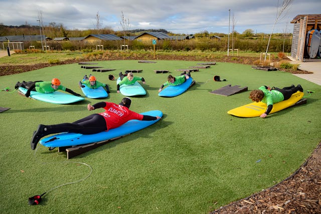 People are instructed how to surf