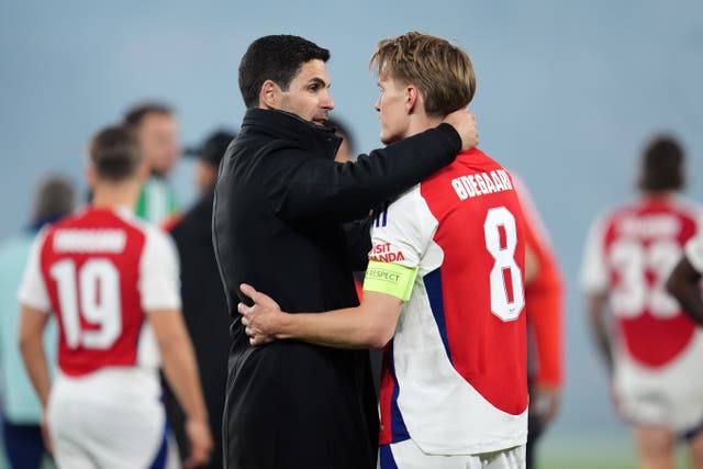 Mikel Arteta, left, embraces Martin Odegaard 
