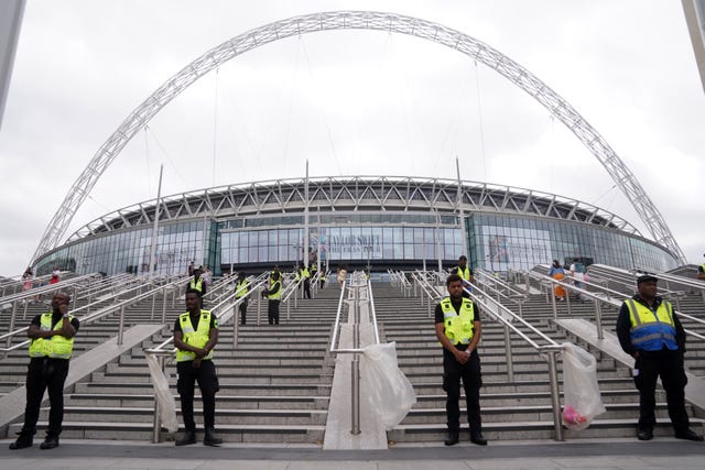 Security guards standing at the steps leading to Wembley Stadium