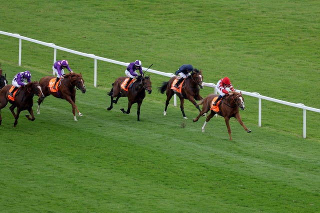 Poniros (centre) in action on the Flat at Newbury 