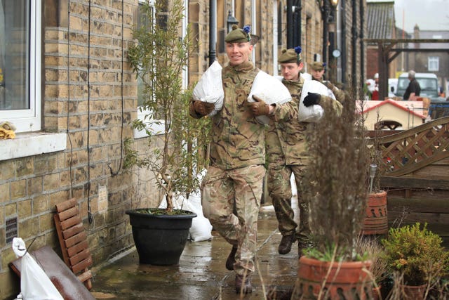 Soldiers from the Highlanders, 4th Battalion, the Royal Regiment of Scotland in Mytholmroyd assisting with flood defences, in the Upper Calder Valley in West Yorkshire 