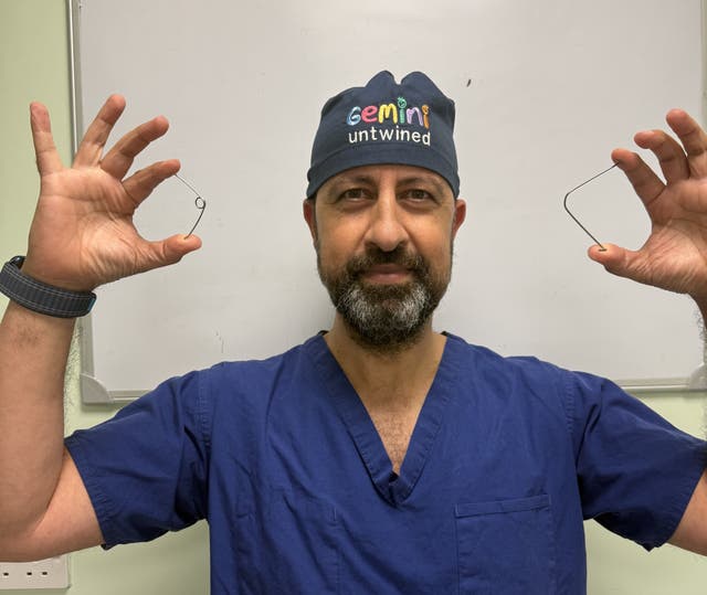 Professor Owase Jeelani, consultant neurosurgeon at Gosh holds the springs used to help Rory 