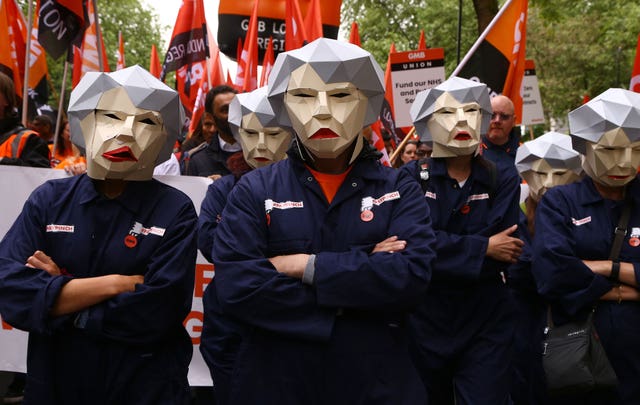 People dressed as Theresa May Bots during the TUC rally (Gareth Fuller/PA)
