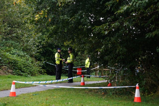 Police officers and police tape at a park