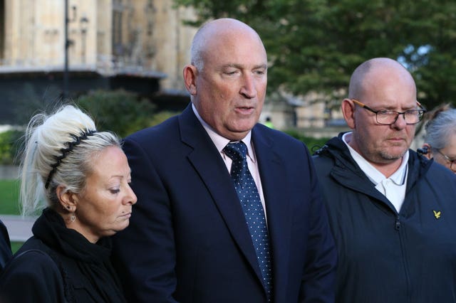 Harry’s mother Charlotte Charles and father Tim Dunn with family spokesman Radd Seiger (centre) (Jonathan Brady/PA)