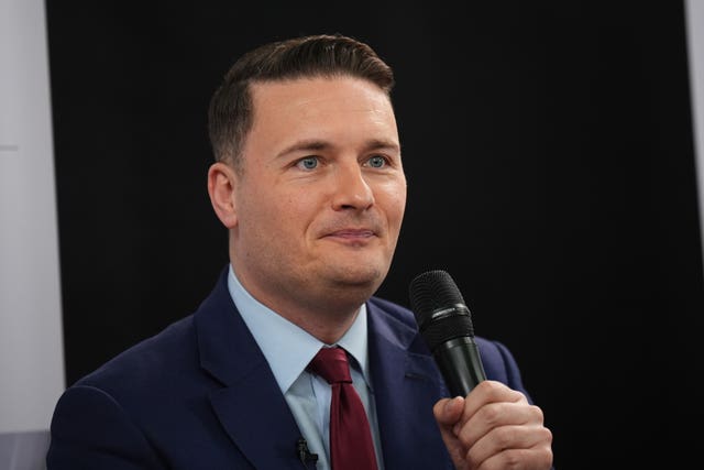 Health Secretary Wes Streeting holding a microphone