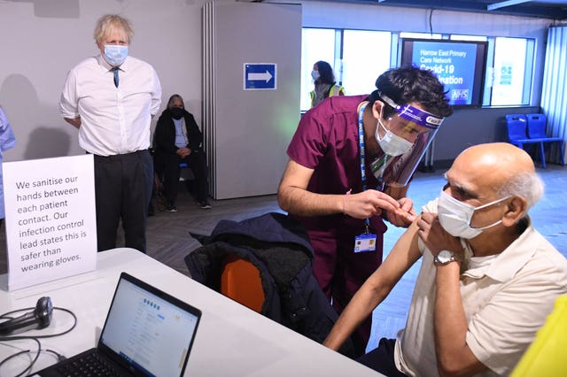 Prime Minister Boris Johnson watches a patient receiving a dose of the vaccine in Barnet (Stefan Rousseau/PA)