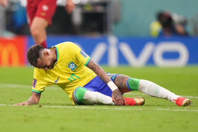 Neymar holds his ankle on Thursday evening (Peter Byrne/PA).