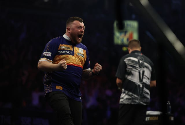 Josh Rock reacts after hitting a nine-dart finish during night four of the Premier League 2026 in Belfast