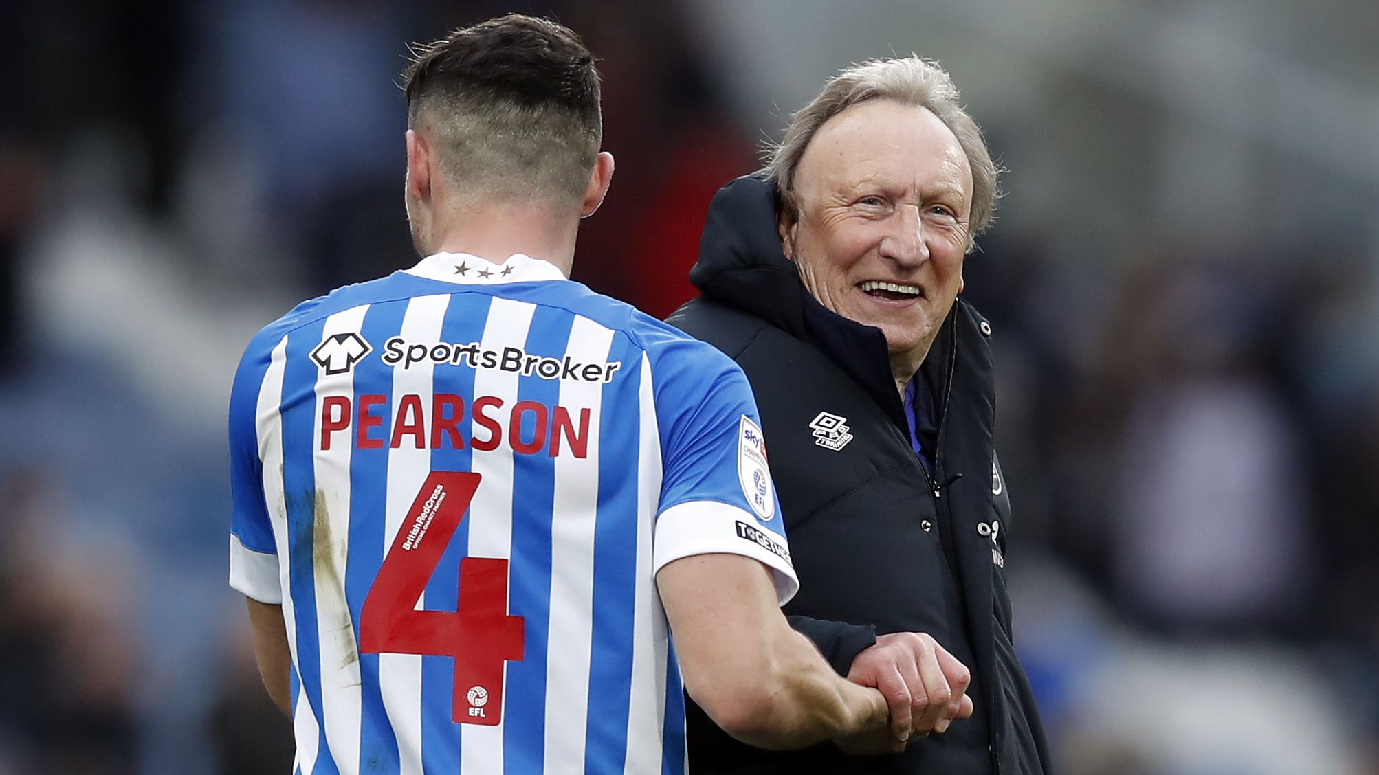 Huddersfield manager Neil Warnock and Matty Pearson celebrate victory (Will Matthews/PA).