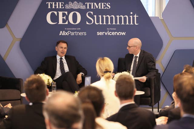 Chancellor Jeremy Hunt, left, on a stage as he speaks during the Times CEO Summit 2024 in London