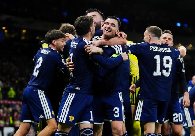 Andy Robertson and Ryan Christie embrace as the Scotland players celebrate