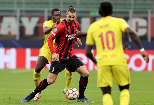 Milan’s Zlatan Ibrahimovic, centre, shields the ball from Ibrahima Konate