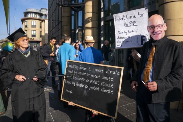 Climate protester dressed as John Swinney