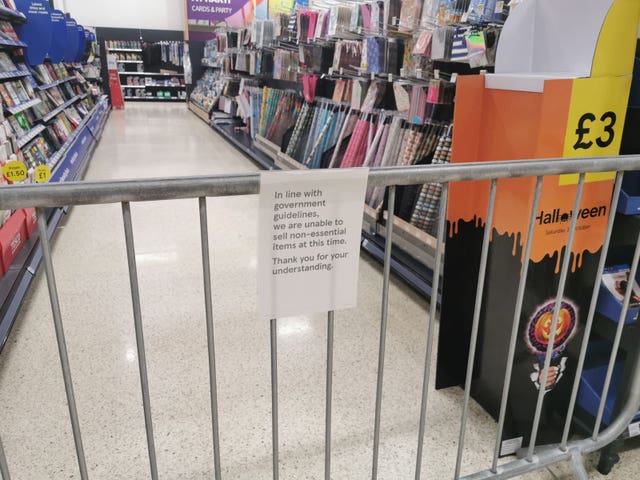 A notice informing customers of the sales of non-essential products at a Tesco Extra store in Pengam Green, Wales 