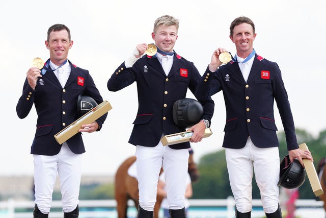 Scott Brash (left), Ben Maher (right) and Harry Charles celebrate with their gold medals 