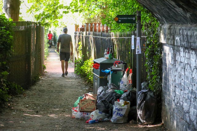 Rubbish piles up next to a bin