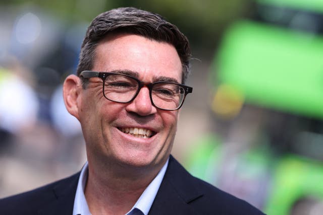 Prime Minister Andy Burnham smiles during a visit to a bus station in Bath, Somerset 