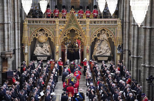 King Charles and members of the royal family follow the Queen's coffin